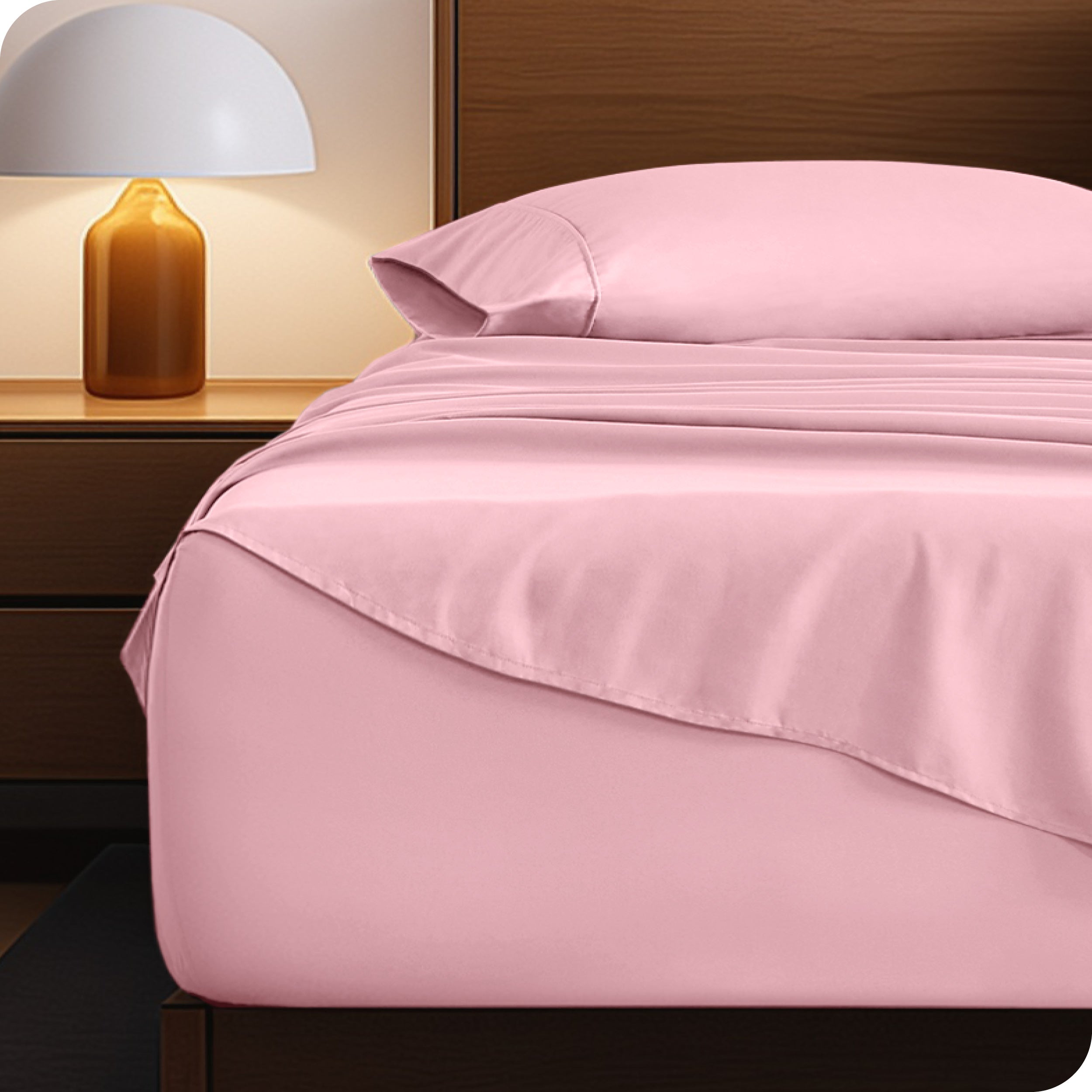 Microfiber bed sheets on a neatly made bed with a wooden headboard and nightstand.