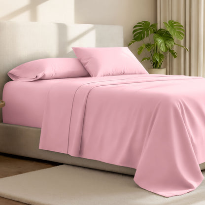 Microfiber bed sheets on a neatly made bed with a wooden headboard and nightstand.