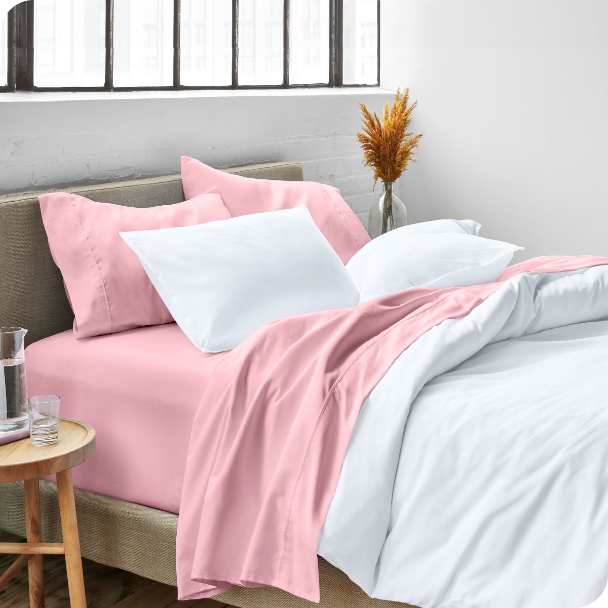 A side view of a bed made with microfiber sheets and a white duvet cover