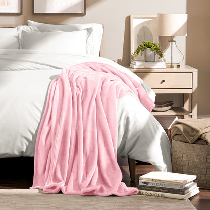 Microplush blanket draped over the corner of a bed