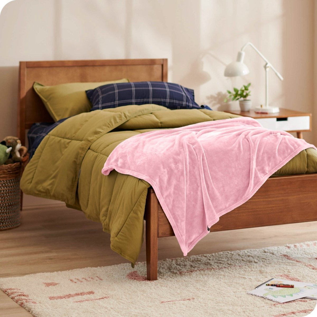 A microplush blanket on a kid's bed