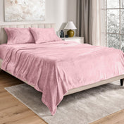 Neatly made bed in a well-lit bedroom.