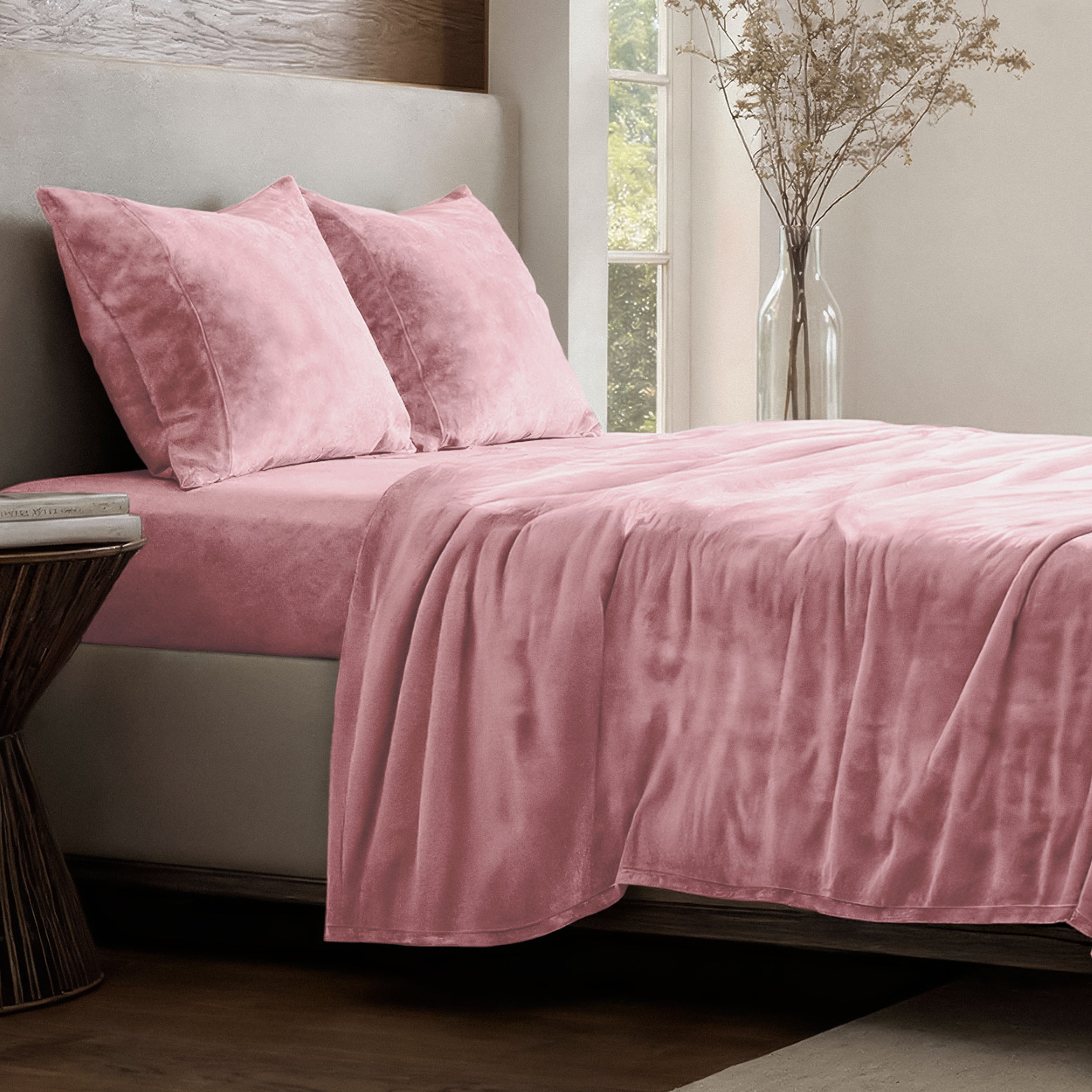 Neatly made bed in a well-lit bedroom.