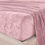 Close-up of the corner of a bed made with microplush sheets