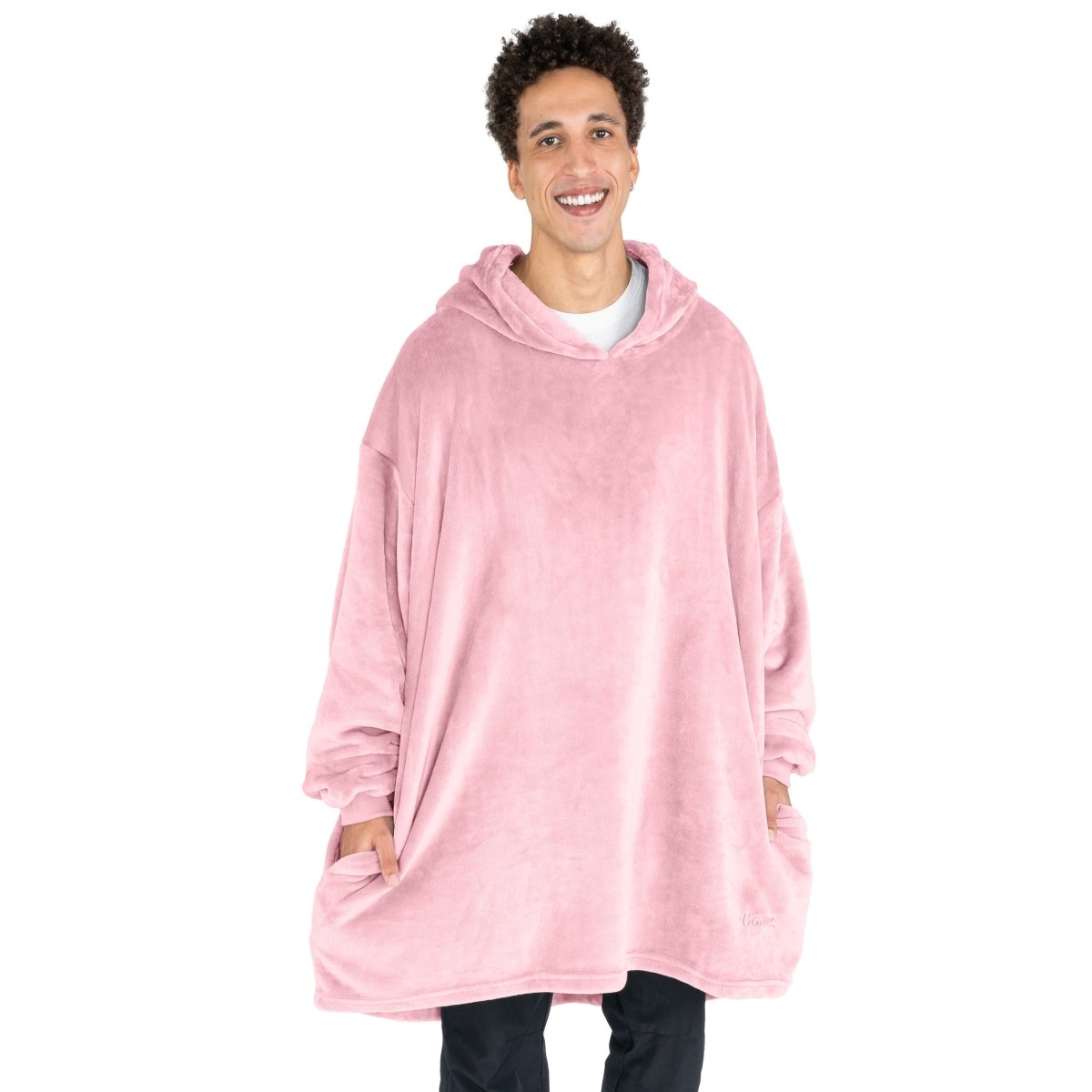 A man standing with a wearable blanket on