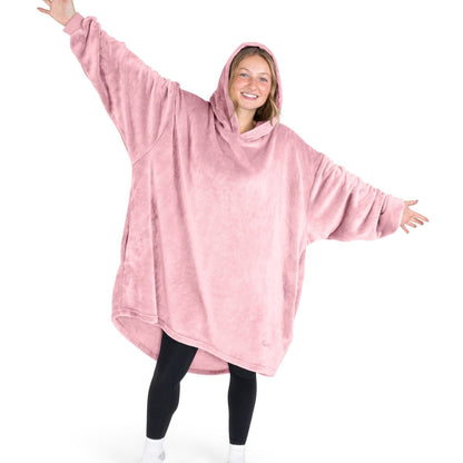A woman wearing a hooded blanket made of microplush, showcasing comfort and warmth