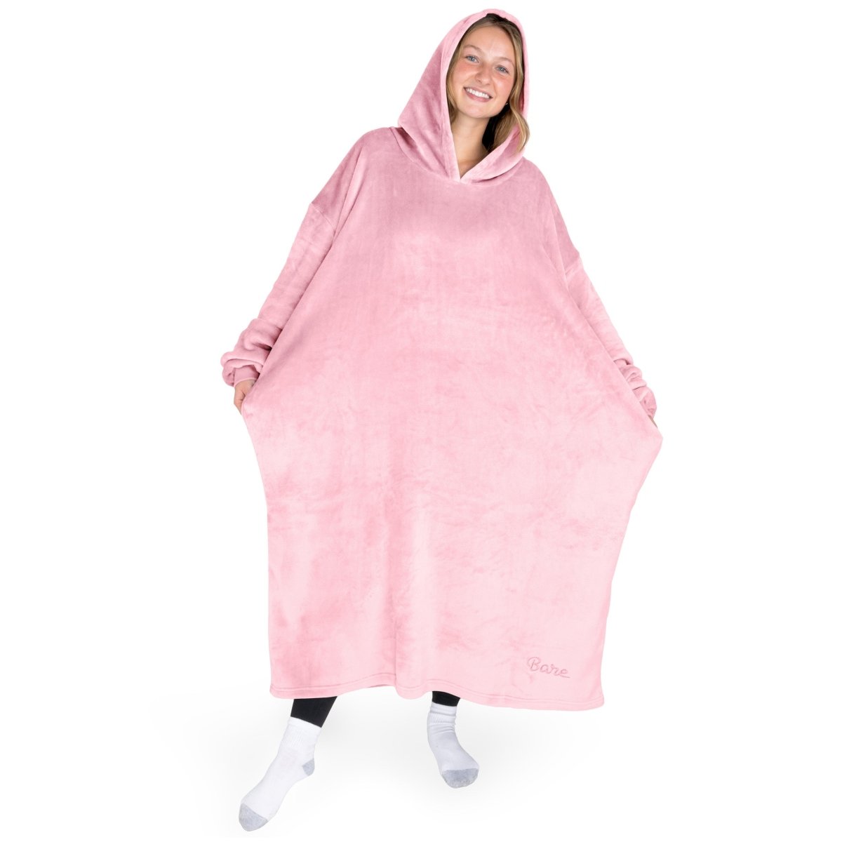 An adult with long microplush wearable blanket on