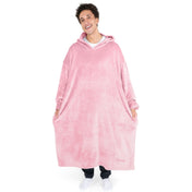 An adult is standing while wearing a long microplush wearable blanket