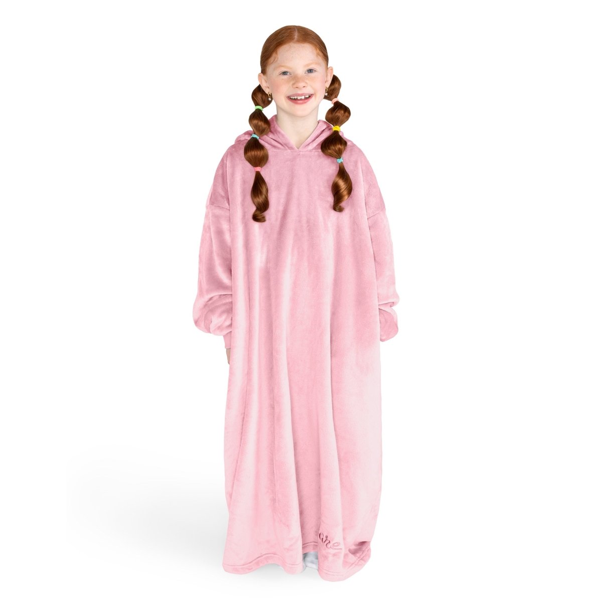 A girl is standing while wearing a long microplush wearable blanket