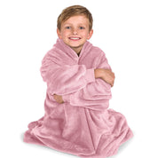 A boy is sitting while in a microplush wearable blanket.