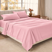 Bed sheets on a neatly made bed in a bright bedroom with large windows.