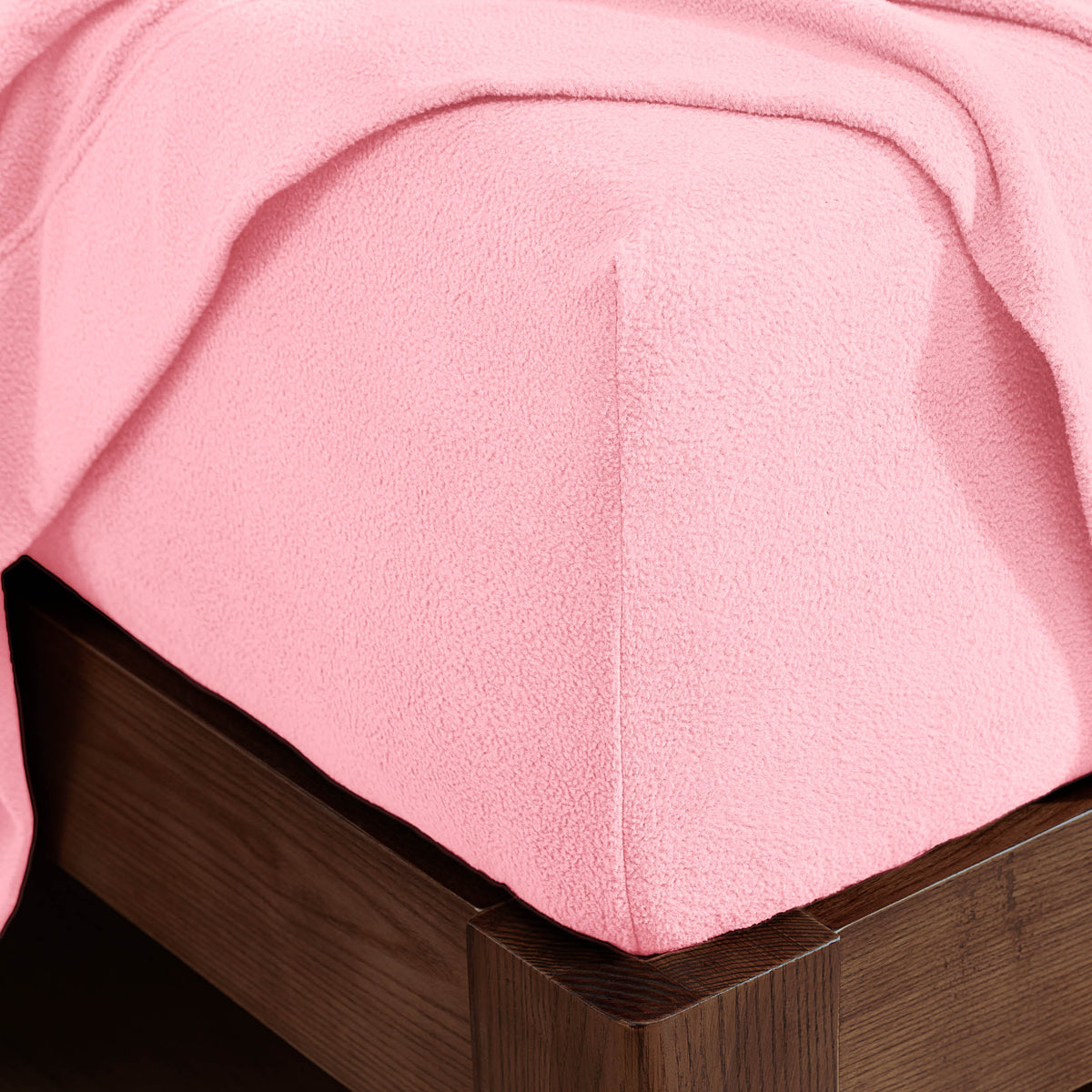 Corner of a mattress with a fitted sheet on it