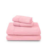 Polar fleece sheets and pillowcases folded and stacked on a white background