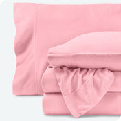 Fleece sheets folded neatly and stacked with pillows inside the pillowcases