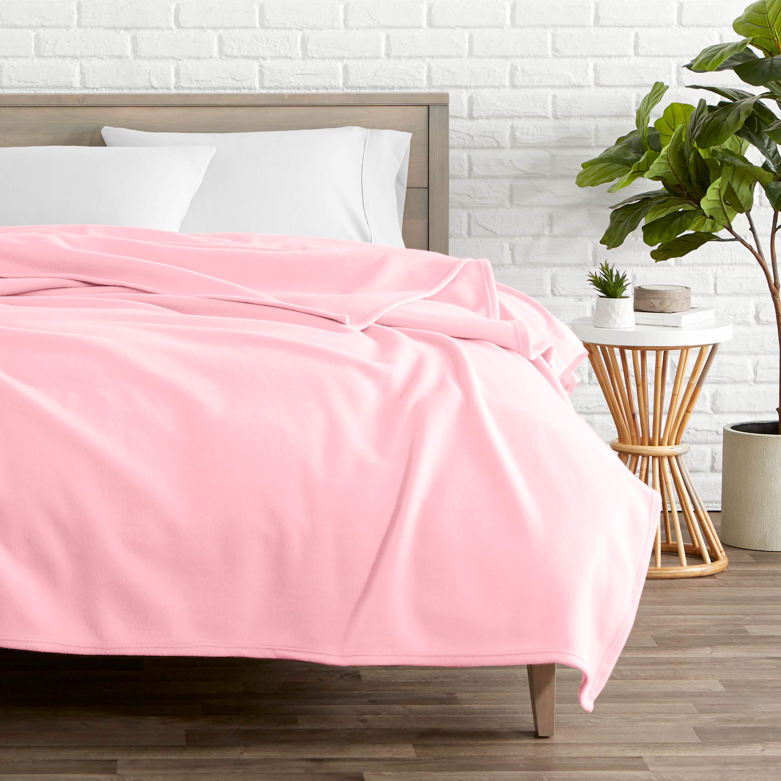 Pink polar fleece blanket on a bed