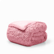A pink shaggy duvet cover folded neatly