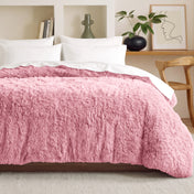 Shaggy duvet on a bed in a bedroom setting with decor elements.