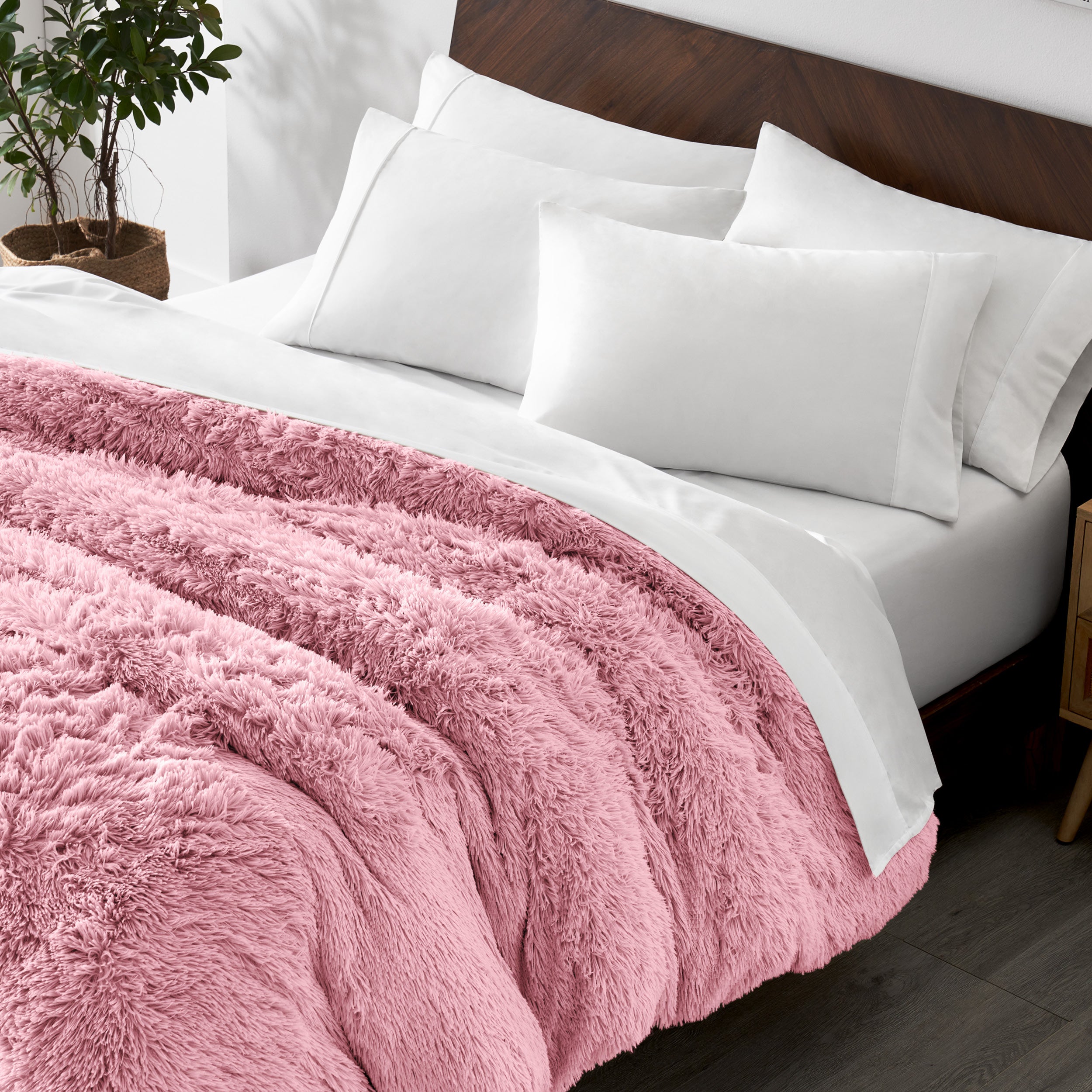 Shaggy duvet cover on a bed with white pillows and a wooden headboard.