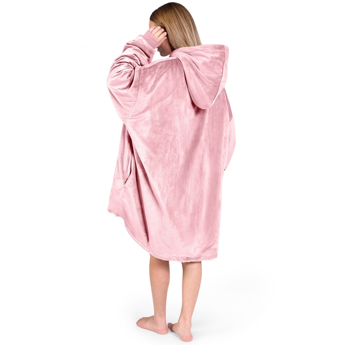 An adult with a hooded wearable blanket on
