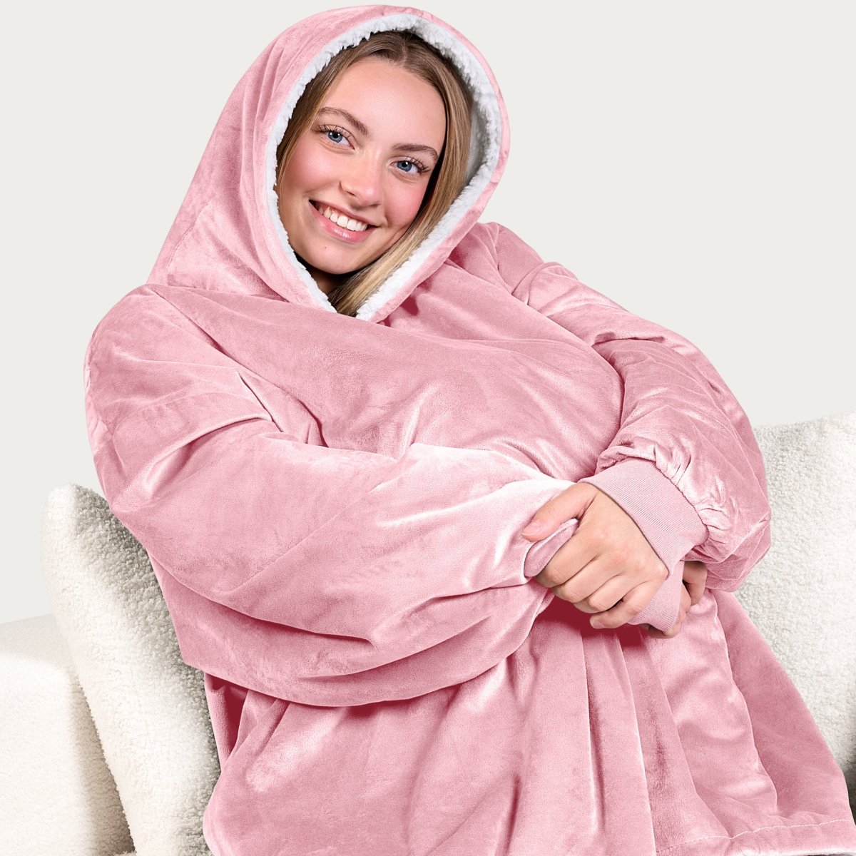 An adult with a hooded wearable blanket on