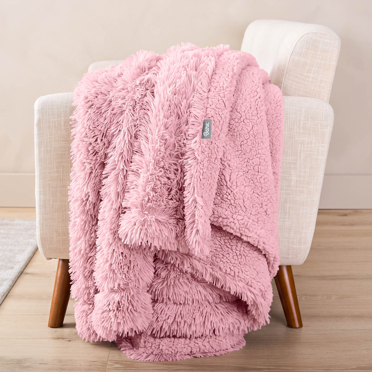 A shaggy blanket draped over the arm of a chair