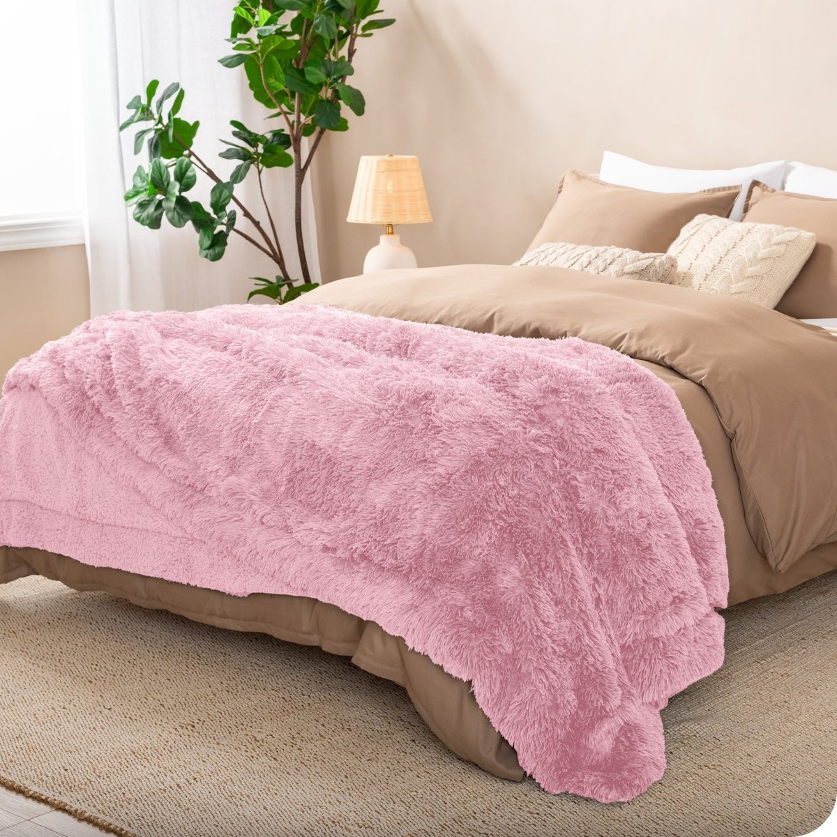 A shaggy faux fur blanket on the end of a bed