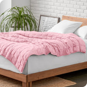 A weighted blanket draped over a bed
