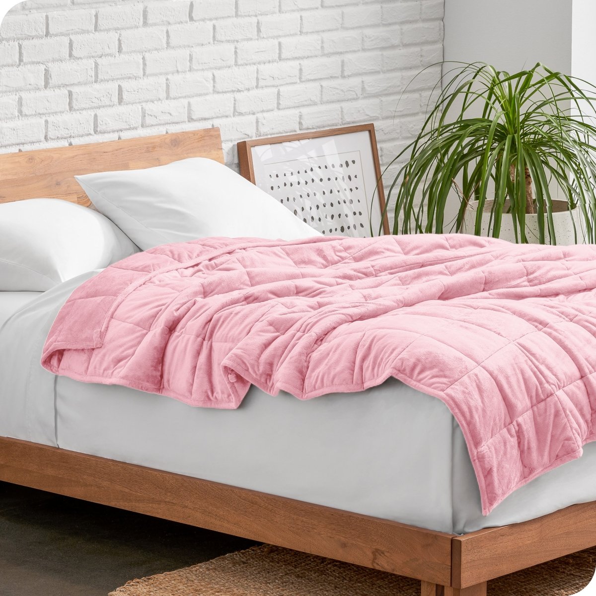 A weighted blanket draped over a bed
