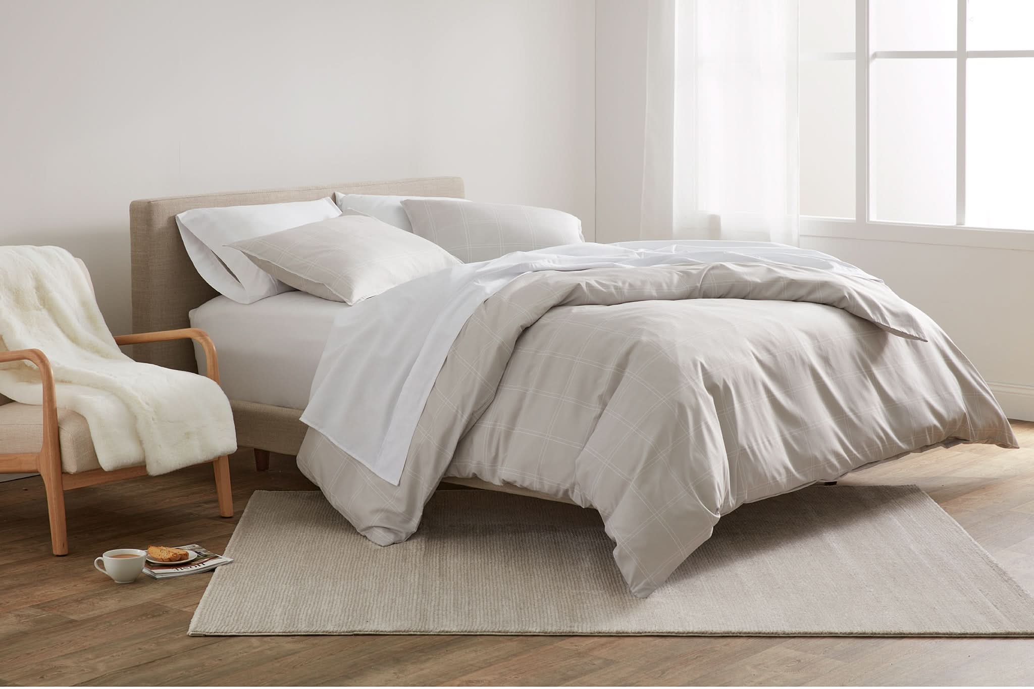 A modern bed with a printed microfiber duvet cover and sham set in stone-white.