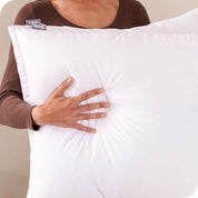 A woman holding a pillow insert