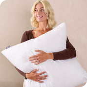 A woman holding a pillow insert