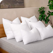 6 pillow inserts on a bed