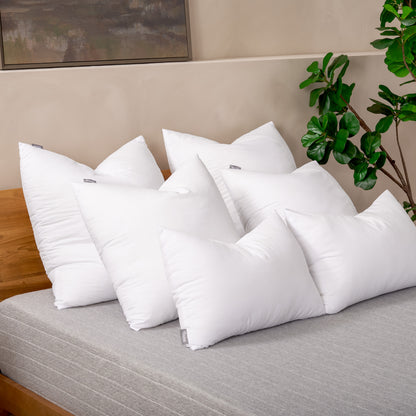 6 pillow inserts on a bed