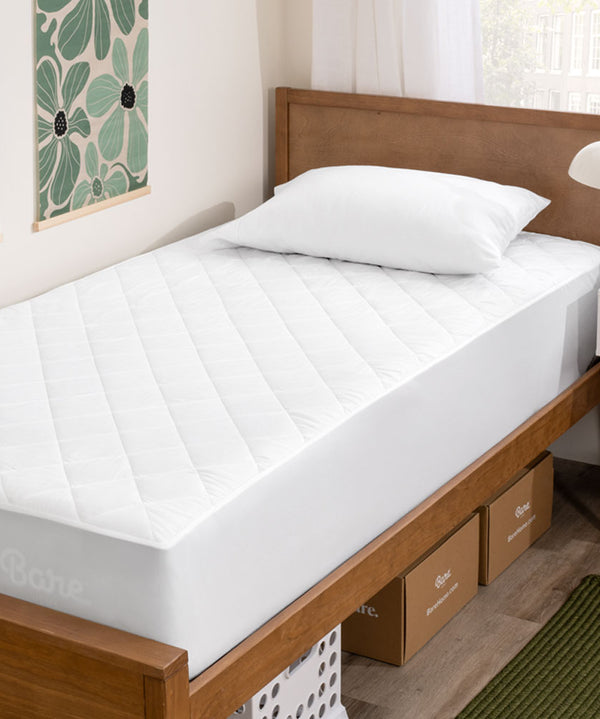 Mattress Pad on a twin xl bed in a dorm room