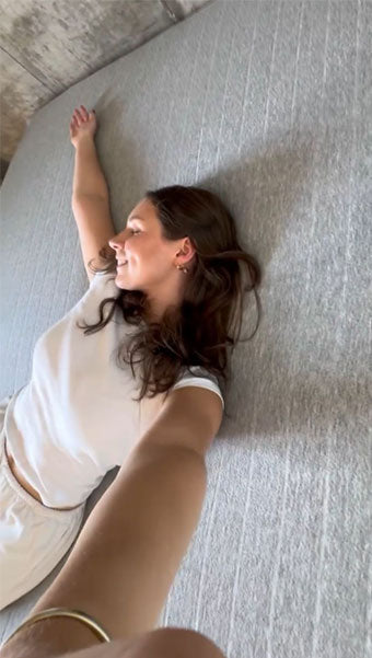 Young lady taking a selfie on a new Bare Home Mattress