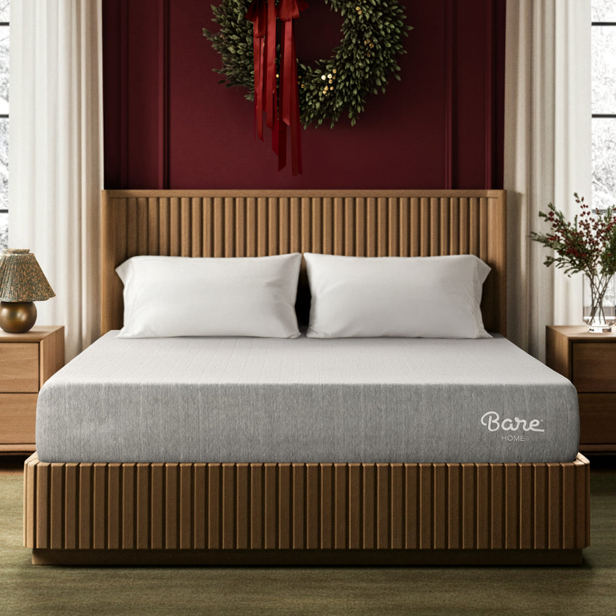 Mattress on a bed with a large wreath on the wall