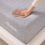 Gray mattress cover with 'Bare' branding, hand touching fabric