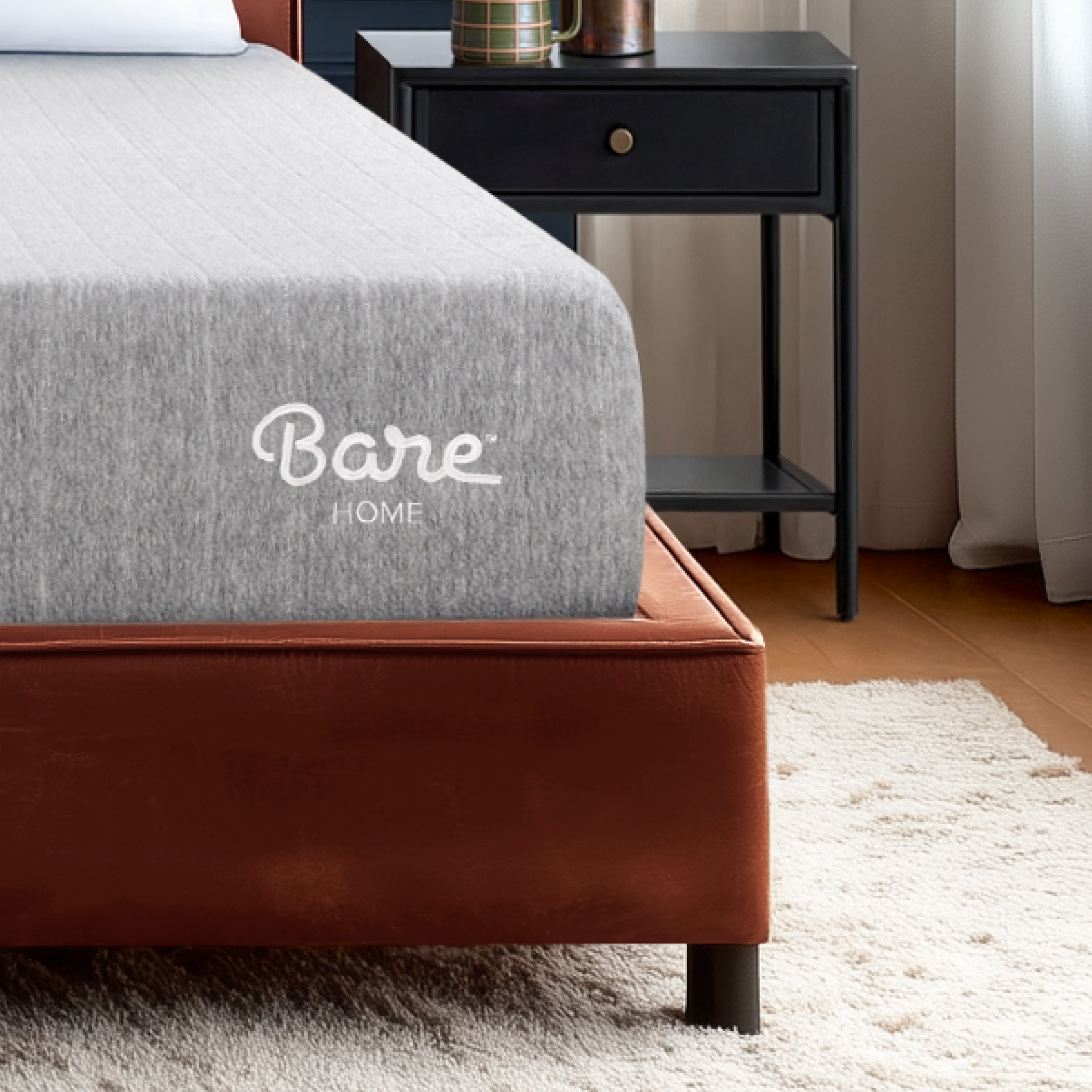 Mattress with a cover on a bed in a bedroom setting.