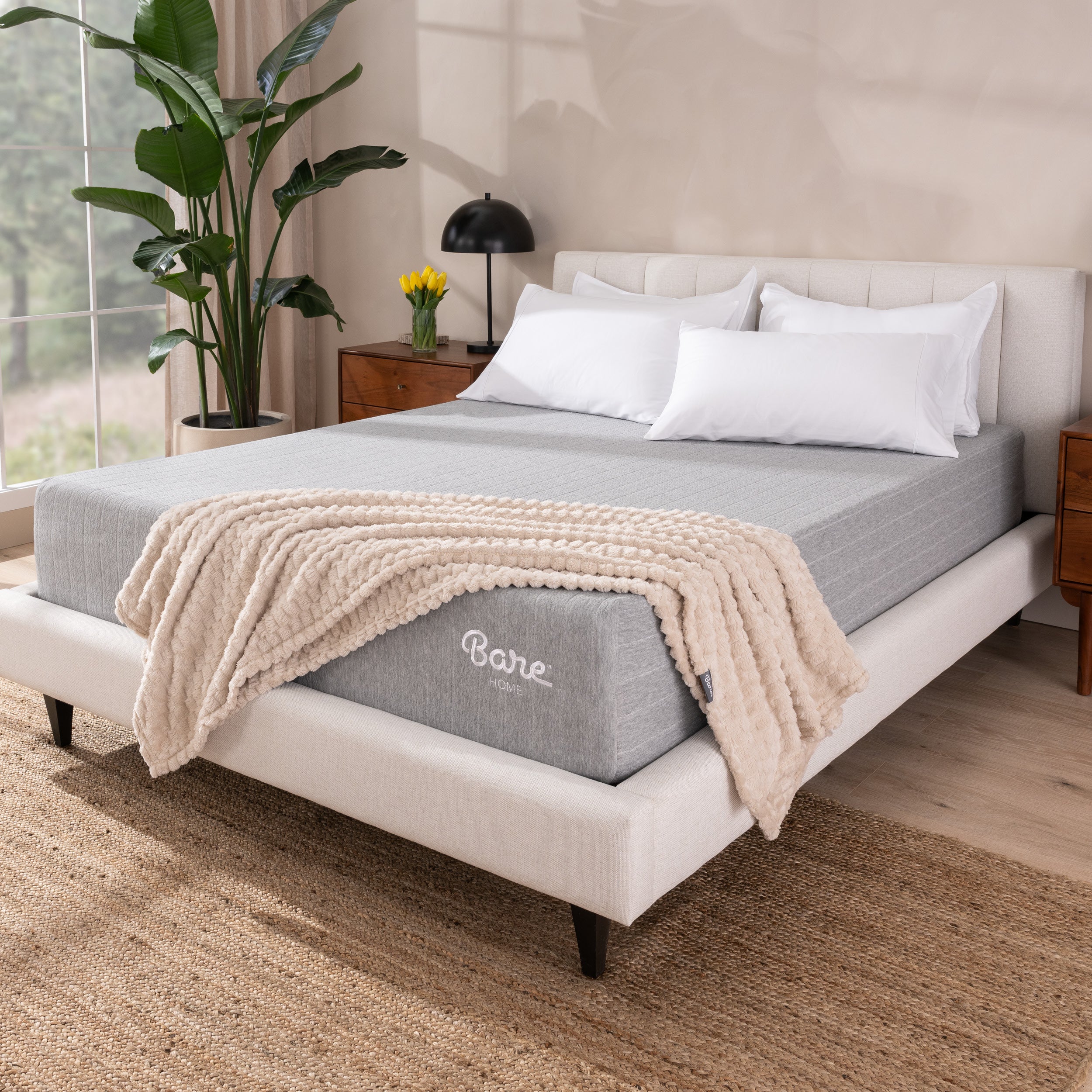Bare mattress in a bedroom setting