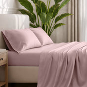 Ultra-soft sheets and pillowcases on a bed with a plant in the background