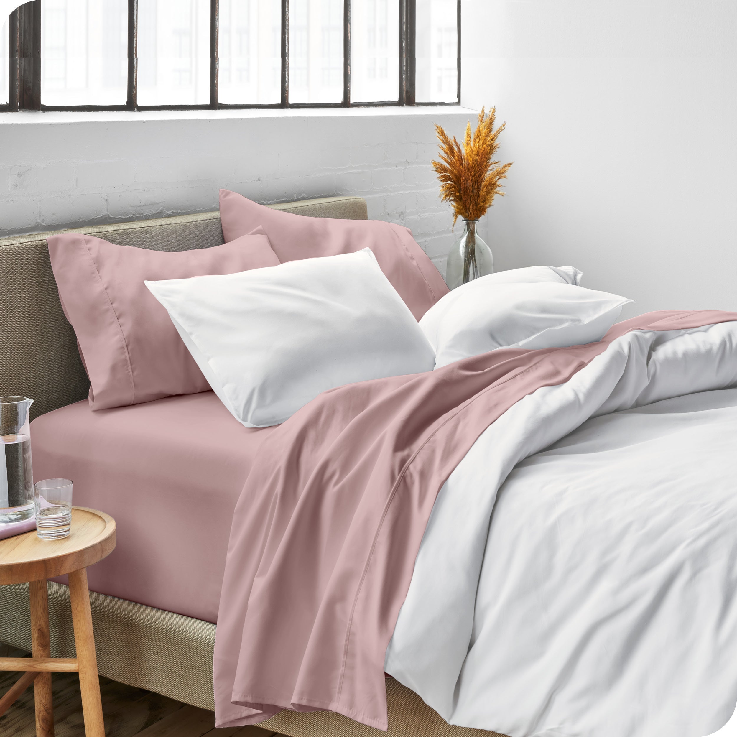 Sheets and a duvet cover on a bed in a bright bedroom