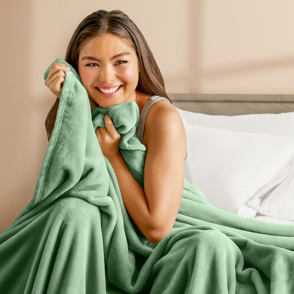 A woman cuddling with a microplush blanket