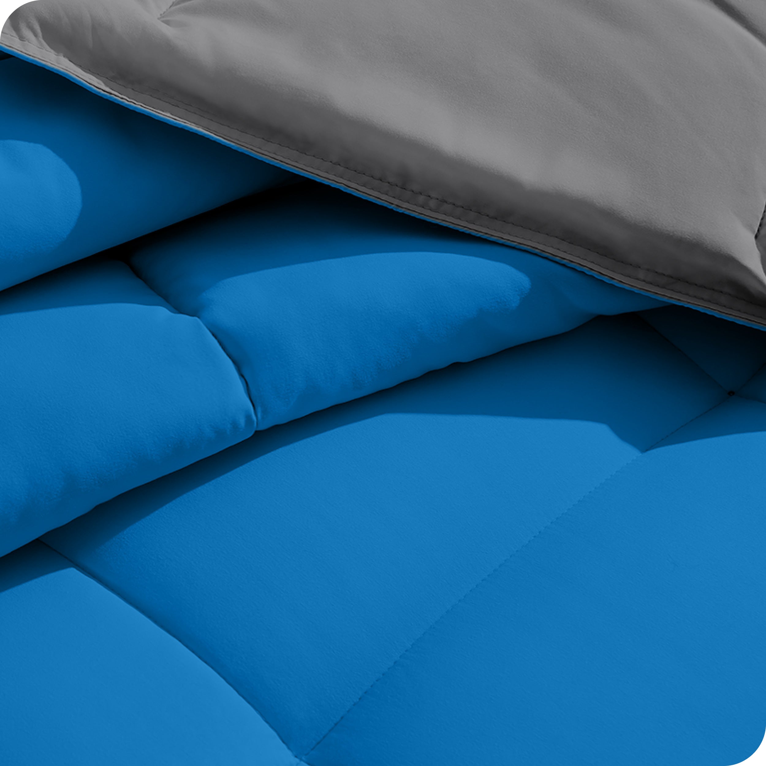 Close up of the reversible comforter showing the box stitching and the two colors