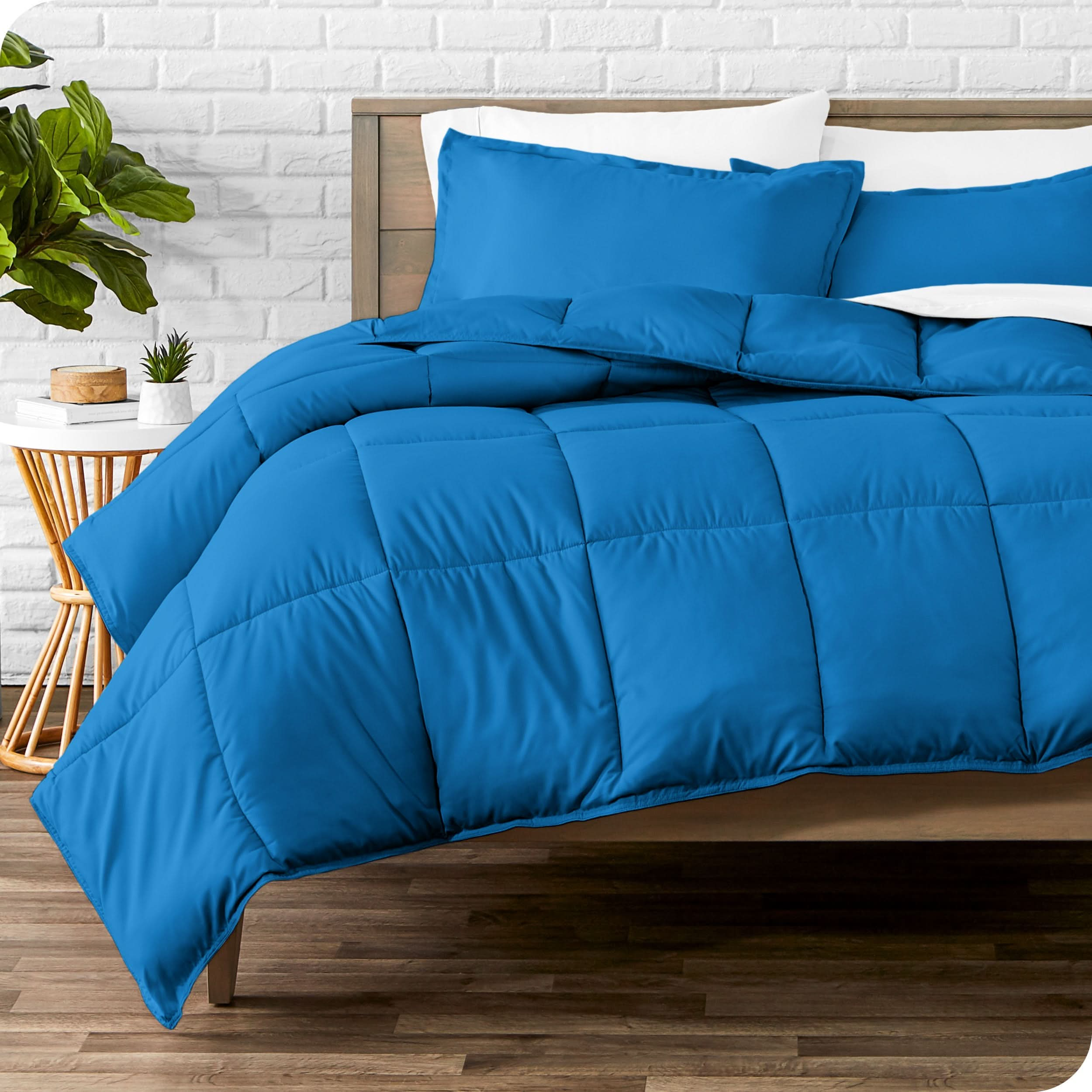 A modern bed with a down alternative comforter set on it