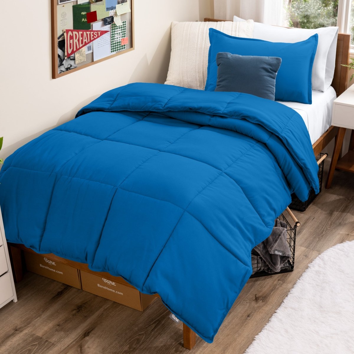 Bed with comforter and pillows in a dorm room