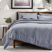 Modern bedroom with a heathered complete bedding set on the bed