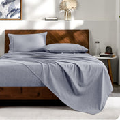 View from the end of a bed with matching sheets and pillowcases.