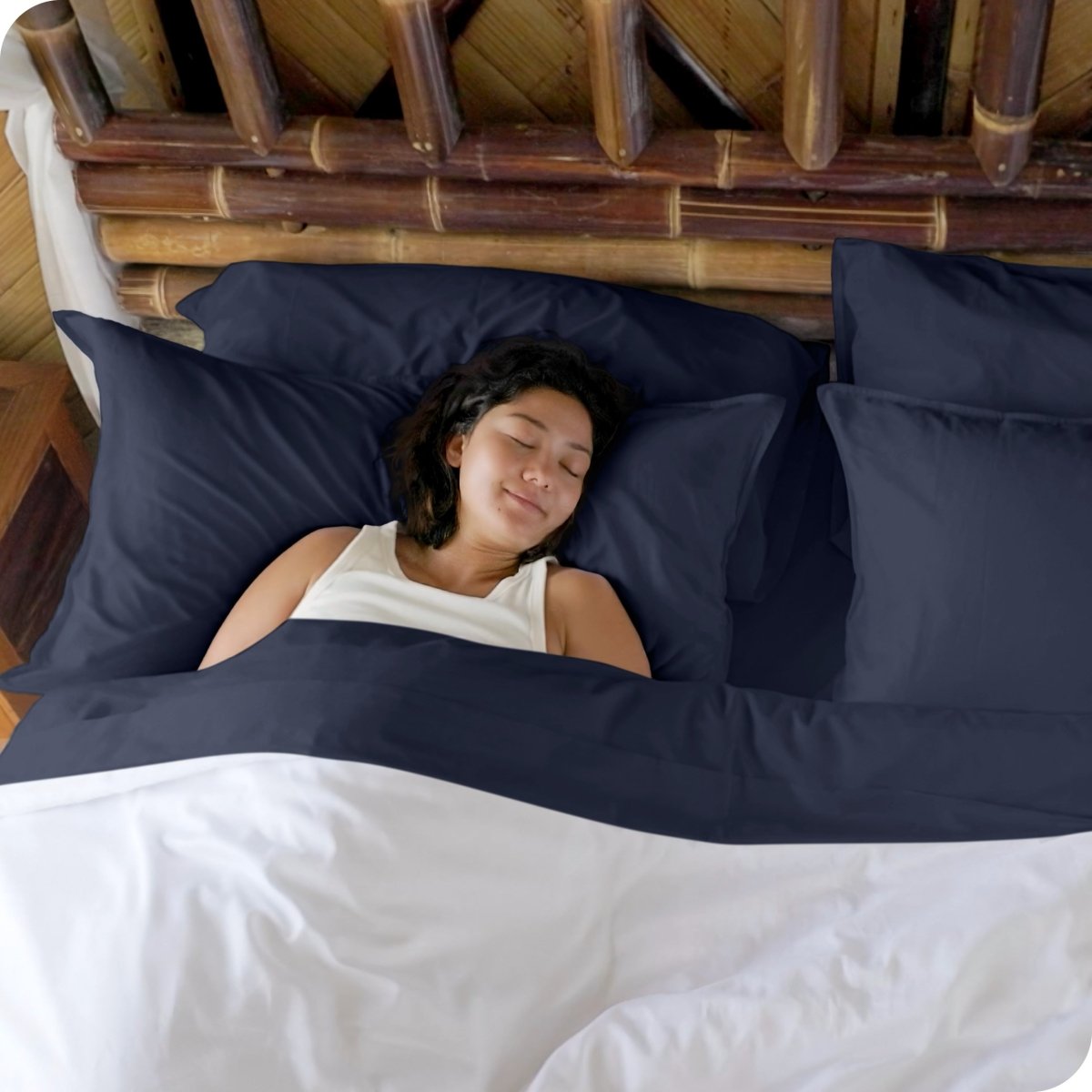 A woman sleeping in a bed made with bamboo sheets