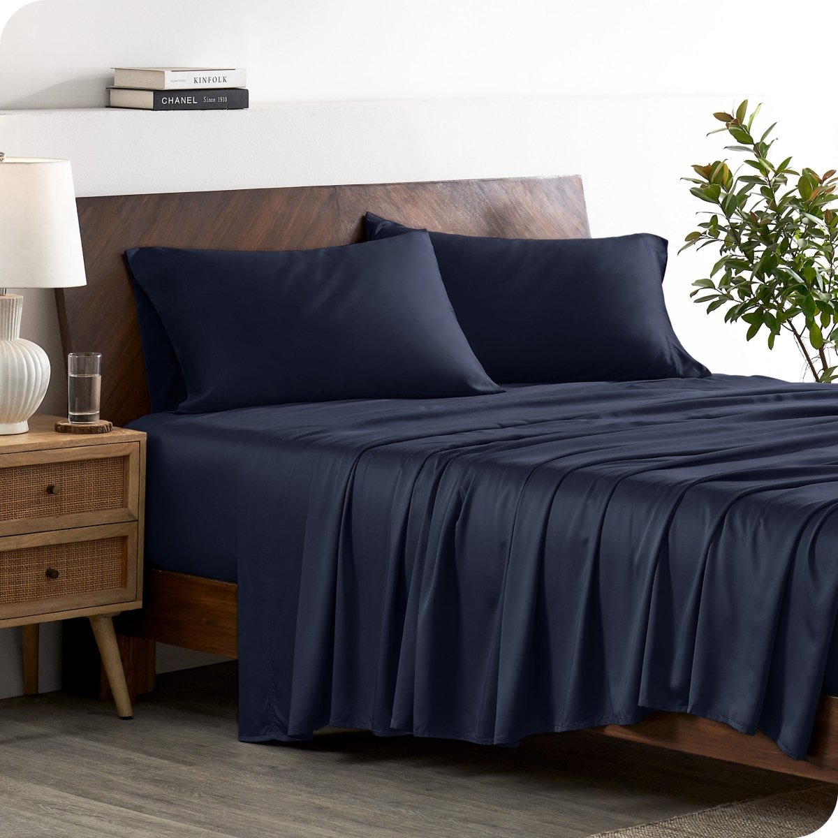 A stylish bed with bamboo sheets and pillowcases, showcasing a sophisticated and elegant bedroom setting.