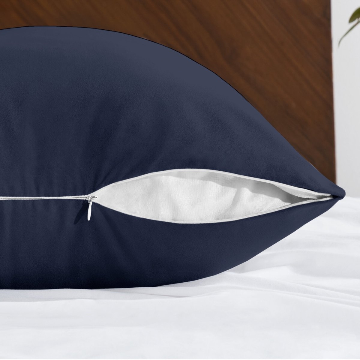 Body pillowcase with a zipper closure on a bed with a wooden headboard